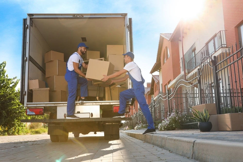two movers unloading boxes