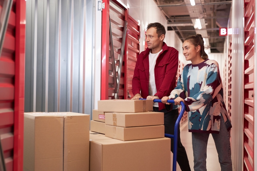 A couple storing their boxes in a storage unit